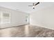 This spacious bedroom features two windows, light gray vinyl floors, and a modern ceiling fan at 1301 Marble St, Charlotte, NC 28208