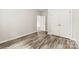Bedroom with wood-look flooring and doors to closets at 1301 Marble St, Charlotte, NC 28208