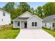 Charming single-story home with a black front door and manicured lawn at 1301 Marble St, Charlotte, NC 28208