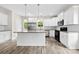 Modern kitchen with white cabinetry, granite countertops, stainless steel appliances, and wood-look flooring at 1301 Marble St, Charlotte, NC 28208