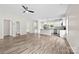 Open-concept living room featuring wood-look floors, ceiling fan, and modern lighting at 1301 Marble St, Charlotte, NC 28208