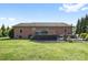 Spacious backyard featuring a large wooden deck perfect for outdoor entertaining with brick barbecue area at 131 Fieldhaven Pl, Troutman, NC 28166