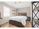 Cozy bedroom featuring hardwood floors, a comfortable bed, and shelves for decor at 131 Fieldhaven Pl, Troutman, NC 28166