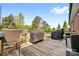 Spacious wooden deck with multiple grills, seating, and wooded view at 131 Fieldhaven Pl, Troutman, NC 28166