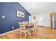 Charming dining room with hardwood floors, a modern chandelier, and access to the kitchen at 131 Fieldhaven Pl, Troutman, NC 28166