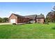 Charming brick home featuring manicured lawn, attached two-car garage, and welcoming front porch on a sunny day at 131 Fieldhaven Pl, Troutman, NC 28166