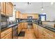 Kitchen features stainless steel appliances, granite counters and slate tile backsplash at 131 Fieldhaven Pl, Troutman, NC 28166