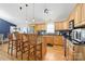 Bright kitchen features stainless steel appliances, wood cabinets, a breakfast bar, and hardwood floors at 131 Fieldhaven Pl, Troutman, NC 28166
