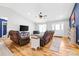 Bright living room features hardwood floors, vaulted ceiling, two leather sofas and neutral color scheme at 131 Fieldhaven Pl, Troutman, NC 28166