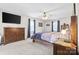 Spacious primary bedroom with ample natural light, ceiling fan, and neutral carpet at 131 Fieldhaven Pl, Troutman, NC 28166