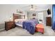 Bright main bedroom with hardwood furniture, an orange accent bench, and a ceiling fan at 131 Fieldhaven Pl, Troutman, NC 28166