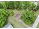 Aerial view of a home with a well-manicured lawn, surrounded by mature trees and lush greenery at 134 Piedmont Dr, Kannapolis, NC 28081