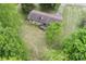 Aerial view of brick home with an expansive backyard and mature trees surrounding the property at 134 Piedmont Dr, Kannapolis, NC 28081