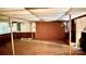 Finished basement featuring paneled walls, tile ceiling and flooring, plus a brick fireplace at 134 Piedmont Dr, Kannapolis, NC 28081