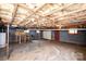 Unfinished basement features a garage door and workbench, offering ample storage and project space at 134 Piedmont Dr, Kannapolis, NC 28081