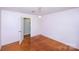 Inviting bedroom with hardwood floors and a decorative chandelier light fixture at 134 Piedmont Dr, Kannapolis, NC 28081