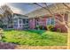 Brick home exterior showcasing a well-manicured lawn and enclosed patio at 138 Victoria Park Dr # 170, Shelby, NC 28150