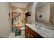Full bathroom with a decorative shower curtain and tile flooring. Vanity with a decorative mirror included at 138 Victoria Park Dr # 170, Shelby, NC 28150