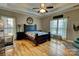 Spacious main bedroom with hardwood floors, tray ceiling, ceiling fan, and large double windows at 138 Victoria Park Dr # 170, Shelby, NC 28150