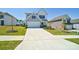 Charming two-story home with manicured lawn, attached two-car garage and concrete driveway at 15520 Capps Rd, Charlotte, NC 28278