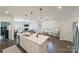 Bright, open kitchen featuring a central island with modern pendant lighting and stainless steel appliances at 15520 Capps Rd, Charlotte, NC 28278