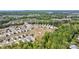 Beautiful aerial view of a neighborhood surrounded by lush greenery and a lake at 15520 Capps Rd, Charlotte, NC 28278