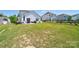Spacious backyard with a patio, outdoor seating, grill, and a well-maintained lawn at 15520 Capps Rd, Charlotte, NC 28278