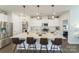 Modern kitchen featuring white cabinets, stainless steel appliances, and seating at the island at 15520 Capps Rd, Charlotte, NC 28278