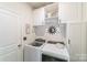 Well-organized laundry room with built-in cabinets above the washer and dryer maximizing available space at 15520 Capps Rd, Charlotte, NC 28278