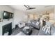 Spacious living room featuring a fireplace, large windows, hardwood floors and open layout at 15520 Capps Rd, Charlotte, NC 28278