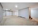 Unfinished basement with concrete flooring, a white garage door, and access door at 1592 Farmington Hills Dr, Conover, NC 28613