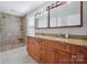 Beautiful bathroom with double sinks, granite counters, custom cabinets, and tiled walk-in shower at 1592 Farmington Hills Dr, Conover, NC 28613