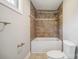 Cozy bathroom with a tiled shower and tub combination with neutral tones at 1592 Farmington Hills Dr, Conover, NC 28613