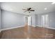 Open bedroom featuring hardwood floors, neutral walls, and direct access to additional rooms at 1592 Farmington Hills Dr, Conover, NC 28613