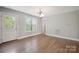 Open dining area featuring hardwood floors, a window, and an exit to the deck at 1592 Farmington Hills Dr, Conover, NC 28613
