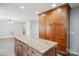 Kitchen island featuring granite countertop, ample cabinets, and views to living room at 1592 Farmington Hills Dr, Conover, NC 28613