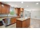 Kitchen featuring stainless steel appliances, granite countertops, and a central island at 1592 Farmington Hills Dr, Conover, NC 28613