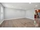 Spacious room features hardwood floors and neutral paint, with a view into the kitchen at 1592 Farmington Hills Dr, Conover, NC 28613