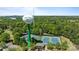 Aerial view featuring tennis courts beside a water tower, surrounded by lush green trees at 16070 Palawan Ct, Tega Cay, SC 29708