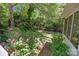 Landscaped back yard area featuring beautiful greenery and a black metal fence at 16070 Palawan Ct, Tega Cay, SC 29708