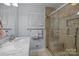 Modern bathroom featuring a glass-enclosed shower, single sink and granite countertop at 16070 Palawan Ct, Tega Cay, SC 29708