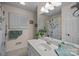 Bathroom featuring ample counter space, a shower/tub combo, and a bright, shuttered window at 16070 Palawan Ct, Tega Cay, SC 29708