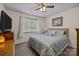 Comfortable bedroom with window views, carpet flooring, and a ceiling fan at 16070 Palawan Ct, Tega Cay, SC 29708