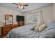 Cozy bedroom featuring matching wooden furniture, a ceiling fan and a bright window at 16070 Palawan Ct, Tega Cay, SC 29708