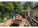 Outdoor deck with comfortable seating, hot tub, and an umbrella for shade at 16070 Palawan Ct, Tega Cay, SC 29708