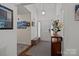 Bright entryway features neutral carpet, wood flooring, bench, and an overhead hanging light at 16070 Palawan Ct, Tega Cay, SC 29708