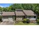 Attractive home with stone facade, brown roof, manicured lawn, and an attached garage at 16070 Palawan Ct, Tega Cay, SC 29708