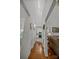Bright hallway leads to the kitchen and living area with pristine white walls and wood flooring at 16070 Palawan Ct, Tega Cay, SC 29708