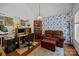 Comfortable home office with wood floors, bright blue wallpaper and generous seating at 16070 Palawan Ct, Tega Cay, SC 29708