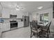 Well-lit kitchen with stainless steel appliances, white cabinets, and a gray dining table set at 16070 Palawan Ct, Tega Cay, SC 29708